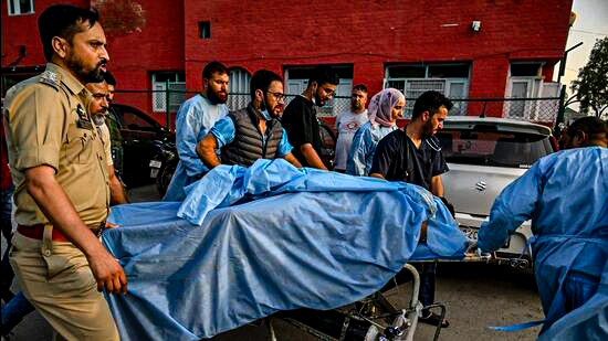Paramedics-and-police-personnel-carry-an-injured-t_1745385638597